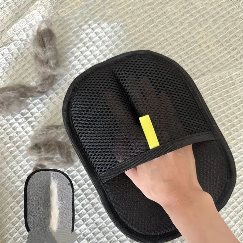 Black pet deshedding glove with textured mesh palm and yellow center strap.